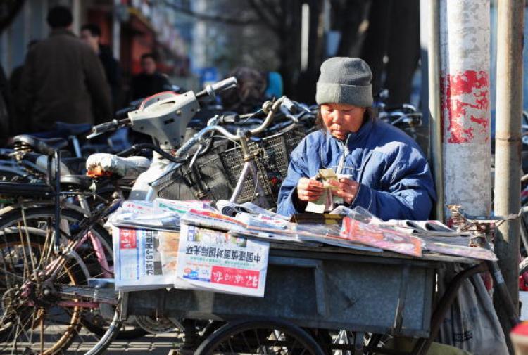 <a><img src="https://www.theepochtimes.com/assets/uploads/2015/09/83811790.jpg" alt="A newspaper vendor counts her one yuan (or RMB) notes in Beijing.  (Frederic J Brown/AFP/Getty Images)" title="A newspaper vendor counts her one yuan (or RMB) notes in Beijing.  (Frederic J Brown/AFP/Getty Images)" width="320" class="size-medium wp-image-1832666"/></a>