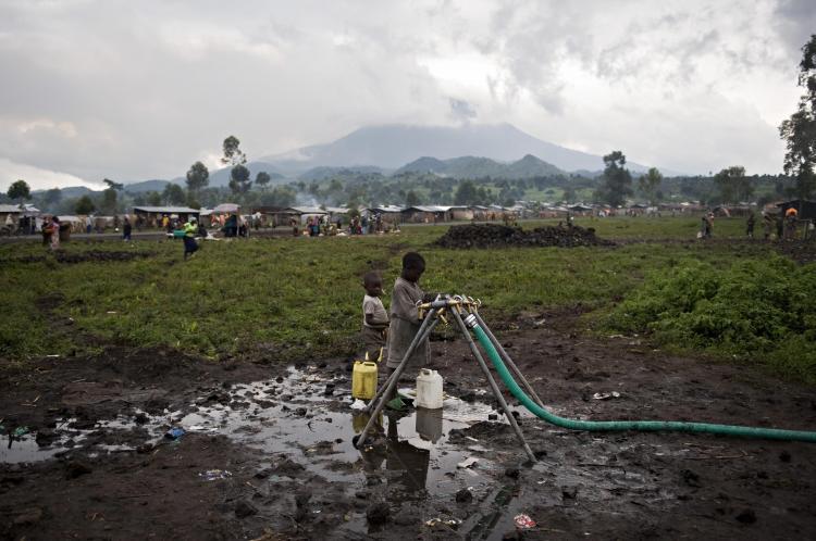 <a><img src="https://www.theepochtimes.com/assets/uploads/2015/09/84512524.jpg" alt="People, who have been displaced by violence in the  Democratic Republic of Congo, get water on January 28, 2009 in their camp for internally displaced people. (Walter Astrada/AFP/Getty Images)" title="People, who have been displaced by violence in the  Democratic Republic of Congo, get water on January 28, 2009 in their camp for internally displaced people. (Walter Astrada/AFP/Getty Images)" width="320" class="size-medium wp-image-1830540"/></a>