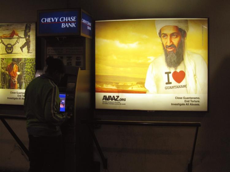 <a><img src="https://www.theepochtimes.com/assets/uploads/2015/09/91244143-bin_laden.jpg" alt="A billboard with Osama bin Laden, leader of al-Qaeda wearing an 'I love Guantanamo' t-shirt is on display at Farragut North Metro Station in Washington D.C. on September 29, 2009.The billboard is an advertisement from Avaaz.org, an organization with membe (Shannon Curran/AFP/Getty Images)" title="A billboard with Osama bin Laden, leader of al-Qaeda wearing an 'I love Guantanamo' t-shirt is on display at Farragut North Metro Station in Washington D.C. on September 29, 2009.The billboard is an advertisement from Avaaz.org, an organization with membe (Shannon Curran/AFP/Getty Images)" width="320" class="size-medium wp-image-1818597"/></a>