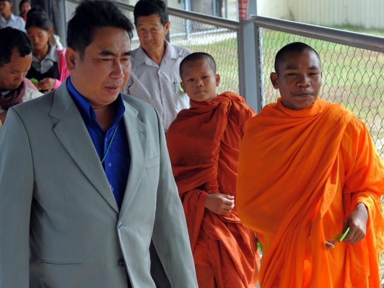 <a><img src="https://www.theepochtimes.com/assets/uploads/2015/09/93443832-AI.jpg" alt="Cambodian Reach Sambath, Chief of the Public Affairs section of the Extraordinary Chambers in the Courts of Cambodia (ECCC), guides monks to attend the trial of former Khmer Rouge prison chief, Kaing Guek Eav (Duch), in Phnom Penh on November 27, 2009. (Tang Chhin Sothy/AFP/Getty Images)" title="Cambodian Reach Sambath, Chief of the Public Affairs section of the Extraordinary Chambers in the Courts of Cambodia (ECCC), guides monks to attend the trial of former Khmer Rouge prison chief, Kaing Guek Eav (Duch), in Phnom Penh on November 27, 2009. (Tang Chhin Sothy/AFP/Getty Images)" width="320" class="size-medium wp-image-1819356"/></a>