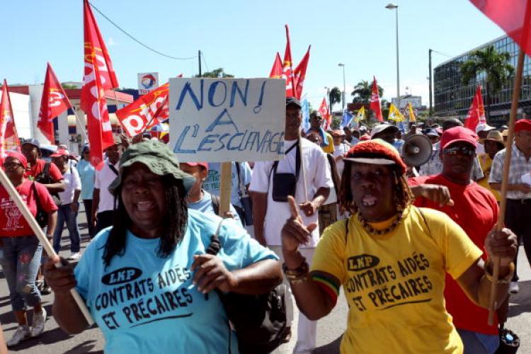 <a><img src="https://www.theepochtimes.com/assets/uploads/2015/09/95700215.jpg" alt="Women hold a banner that reads 'Stop the slavery' during a demonstration in Pointe-a-Pitre on the French Caribbean island of Guadeloupe. (Julien Tack/AFP/Getty Images)" title="Women hold a banner that reads 'Stop the slavery' during a demonstration in Pointe-a-Pitre on the French Caribbean island of Guadeloupe. (Julien Tack/AFP/Getty Images)" width="320" class="size-medium wp-image-1823961"/></a>