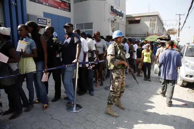 <a><img src="https://www.theepochtimes.com/assets/uploads/2015/09/96143248.jpg" alt="Nepalese UN Peacekeepers provide security as Haitians stand in line at a bank branch waiting for it to open January 23, in Port-au-Prince, Haiti.   (Sophia Paris/Getty Images )" title="Nepalese UN Peacekeepers provide security as Haitians stand in line at a bank branch waiting for it to open January 23, in Port-au-Prince, Haiti.   (Sophia Paris/Getty Images )" width="320" class="size-medium wp-image-1811117"/></a>