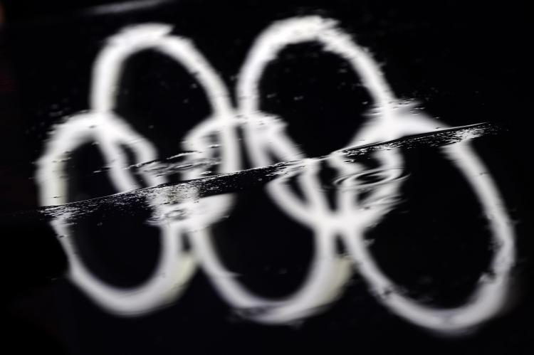 <a><img src="https://www.theepochtimes.com/assets/uploads/2015/09/96671523Rings.jpg" alt="The Olympic rings are reflected in a rain puddle at the Vancouver 2010 Winter Olympics.  (Fabrice Coffrini/AFP/Getty Images)" title="The Olympic rings are reflected in a rain puddle at the Vancouver 2010 Winter Olympics.  (Fabrice Coffrini/AFP/Getty Images)" width="320" class="size-medium wp-image-1823114"/></a>