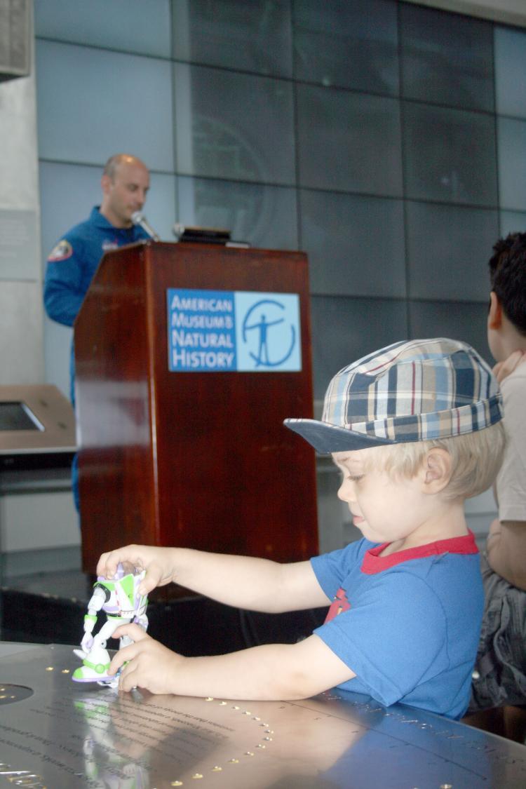 <a><img src="https://www.theepochtimes.com/assets/uploads/2015/09/Astronaut.jpg" alt="A Little boy plays with a Buzz LightYear toy as astronaut Garrett E. Reisman speaks to kids at the American Museum of Natural History on Tuesday about space travel after his three-month mission on the International Space Station.  (Katy Mantyk/Epoch Times)" title="A Little boy plays with a Buzz LightYear toy as astronaut Garrett E. Reisman speaks to kids at the American Museum of Natural History on Tuesday about space travel after his three-month mission on the International Space Station.  (Katy Mantyk/Epoch Times)" width="320" class="size-medium wp-image-1833882"/></a>