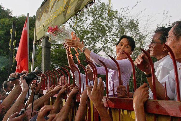 <a><img src="https://www.theepochtimes.com/assets/uploads/2015/09/Aung_San_Suu_Kyi_106804908.jpg" alt="Aung San Suu Kyi, Burma democracy leader, holds a bouquet of flowers as she appears at the gate of her house after her release in Yangon on November 13. Aung San Suu Kyi walked free from the lakeside home that has been her prison for most of the past two years. (Soe Than Win/AFP/Getty Images)" title="Aung San Suu Kyi, Burma democracy leader, holds a bouquet of flowers as she appears at the gate of her house after her release in Yangon on November 13. Aung San Suu Kyi walked free from the lakeside home that has been her prison for most of the past two years. (Soe Than Win/AFP/Getty Images)" width="320" class="size-medium wp-image-1812203"/></a>
