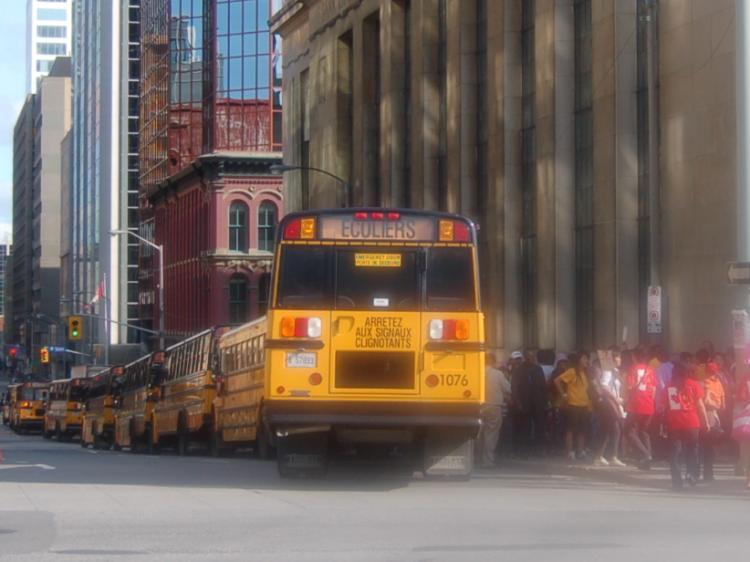 A long line of school buses sits in downtown Ottawa near Parliament Hill. The Chinese embassy in Ottawa made a large-scale effort this week to get Chinese people from across the country to rally in Ottawa in support of Hu Jintao's arrival. Some students studying in Canada on Chinese state scholarships were even told that attending the rallies was mandatory. (Epoch Times)