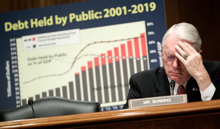 <a><img src="https://www.theepochtimes.com/assets/uploads/2015/09/Bunning96349781.jpg" alt="U.S. Sen. Jim Bunning (R-KY) listens during a hearing before the Senate Finance Committee on Capitol Hill last month. The senator conceded after blocking a 30-day extension bill for funding federal programs. (Alex Wong/Getty Images)" title="U.S. Sen. Jim Bunning (R-KY) listens during a hearing before the Senate Finance Committee on Capitol Hill last month. The senator conceded after blocking a 30-day extension bill for funding federal programs. (Alex Wong/Getty Images)" width="320" class="size-medium wp-image-1822450"/></a>