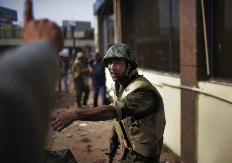 <a><img src="https://www.theepochtimes.com/assets/uploads/2015/09/EGYPT-SOLDIER-108798396.jpg" alt="CAUGHT IN THE MIDDLE: An Egyptian soldier tries to bring some order during violent clashes between pro- and anti-Egyptian government demonstrators at Cairo's Tahrir Square on Feb. 3, on the 10th day of protests calling for the ouster of embattled President Hosni Mubarak. The army has attempted to remain neutral throughout the chaos. (Marco Longari/AFP/Getty Images)" title="CAUGHT IN THE MIDDLE: An Egyptian soldier tries to bring some order during violent clashes between pro- and anti-Egyptian government demonstrators at Cairo's Tahrir Square on Feb. 3, on the 10th day of protests calling for the ouster of embattled President Hosni Mubarak. The army has attempted to remain neutral throughout the chaos. (Marco Longari/AFP/Getty Images)" width="320" class="size-medium wp-image-1808783"/></a>