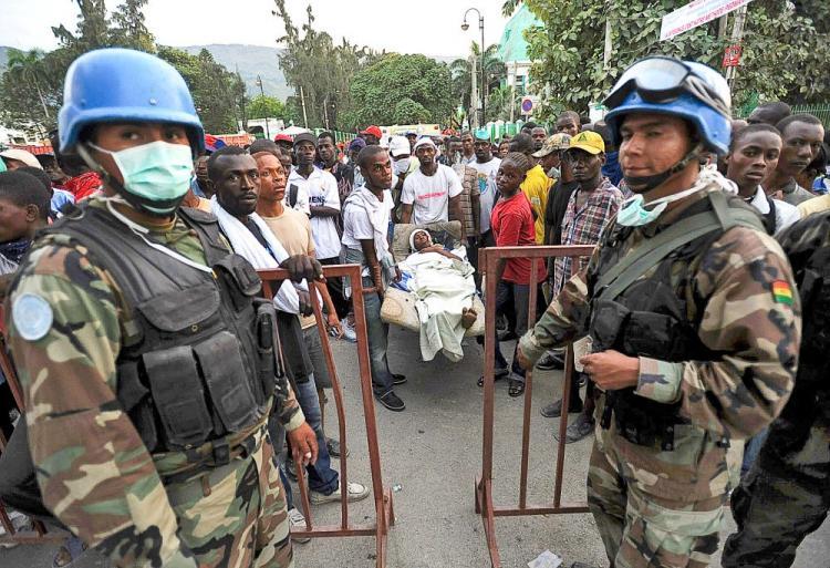 <a><img src="https://www.theepochtimes.com/assets/uploads/2015/09/HAITI-COLOUR.jpg" alt="Bolivian U.N. Blue Helmet soldiers stand guard at an aid center as a group of Haitians carry a victim in Port-au-Prince on Jan. 14, following the devastating earthquake that rocked Haiti on Jan. 12.  (Juan Barreto/AFP/Getty Images)" title="Bolivian U.N. Blue Helmet soldiers stand guard at an aid center as a group of Haitians carry a victim in Port-au-Prince on Jan. 14, following the devastating earthquake that rocked Haiti on Jan. 12.  (Juan Barreto/AFP/Getty Images)" width="320" class="size-medium wp-image-1823973"/></a>