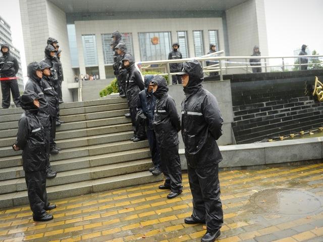 Policemen stand guard outside the Intermediate People's Court in Hefei City, Anhui Province, on Aug. 10. Gu Kailai was tried here for the murder of British businessman Neil Heywoord. (Peter Parks/AFP/GettyImages)