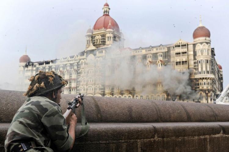 <a><img src="https://www.theepochtimes.com/assets/uploads/2015/09/INDIA-C.jpg" alt="Flames and smoke gush out of the historic historic Taj Mahal Hotel in Mumbai on Nov. 27, 2008, one of the sites of attacks by militant gunmen. Up to 100 people were killed and around 100 more wounded in coordinated attacks by gunmen in India's commercial capital Mumbai with two five-star hotels among the targets of gunmen armed with powerful assault rifles and grenades. (Indranil Mukherjee/AFP/Getty Images)" title="Flames and smoke gush out of the historic historic Taj Mahal Hotel in Mumbai on Nov. 27, 2008, one of the sites of attacks by militant gunmen. Up to 100 people were killed and around 100 more wounded in coordinated attacks by gunmen in India's commercial capital Mumbai with two five-star hotels among the targets of gunmen armed with powerful assault rifles and grenades. (Indranil Mukherjee/AFP/Getty Images)" width="320" class="size-medium wp-image-1823379"/></a>