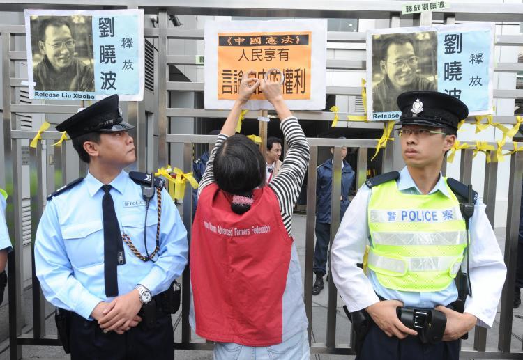 <a><img src="https://www.theepochtimes.com/assets/uploads/2015/09/Liu-Xiaobo-Dec25-Getty95247793.jpg" alt="A woman puts a sign on the gate outside the China liaison office in Hong Kong to protest the Chinese regime's jailing of dissident Lui Xiaobo on Dec. 25, 2009, after a Beijing court sentenced the prominent writer and pro-democracy activist to 11 years in prison despite international calls for his release.  (MIKE CLARKE/AFP/Getty Images)" title="A woman puts a sign on the gate outside the China liaison office in Hong Kong to protest the Chinese regime's jailing of dissident Lui Xiaobo on Dec. 25, 2009, after a Beijing court sentenced the prominent writer and pro-democracy activist to 11 years in prison despite international calls for his release.  (MIKE CLARKE/AFP/Getty Images)" width="320" class="size-medium wp-image-1824463"/></a>