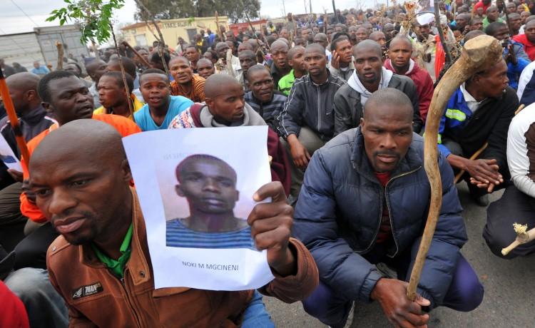 <a><img class="size-full wp-image-1782200" title="A miner carries a photo of a killed miner as thousands of striking workers singing and carrying sticks march on a South African mine in Marikana on Sept. 5 as police were accused of shooting miners in cold blood during a crackdown that killed 34. (Alexander Joe/AFP/GettyImages)" src="https://www.theepochtimes.com/assets/uploads/2015/09/Miners_151263094.jpg" alt="" width="750" height="460"/></a>