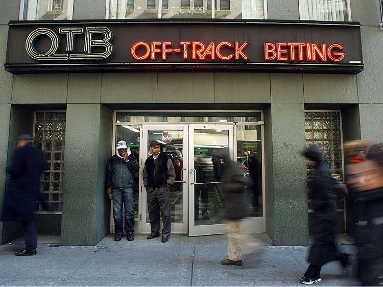 <a><img src="https://www.theepochtimes.com/assets/uploads/2015/09/OTB80053983.jpg" alt="People walk past an Off-Track Betting (OTB) parlor in midtown Manhattan February 28, 2008 in New York City. (Mario Tama/Getty Images)" title="People walk past an Off-Track Betting (OTB) parlor in midtown Manhattan February 28, 2008 in New York City. (Mario Tama/Getty Images)" width="320" class="size-medium wp-image-1822043"/></a>
