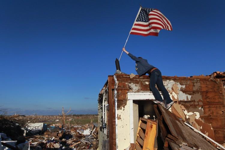 <a><img src="https://www.theepochtimes.com/assets/uploads/2015/09/PRINT_Flag_114803567.jpg" alt="AMERICAN SPIRIT: Crystal Kilpatrick plants an American flag on the house of a family friend May 26 after the home was destroyed by a tornado in Joplin, Mo. (Joe Raedle/Getty Images)" title="AMERICAN SPIRIT: Crystal Kilpatrick plants an American flag on the house of a family friend May 26 after the home was destroyed by a tornado in Joplin, Mo. (Joe Raedle/Getty Images)" width="575" class="size-medium wp-image-1803319"/></a>