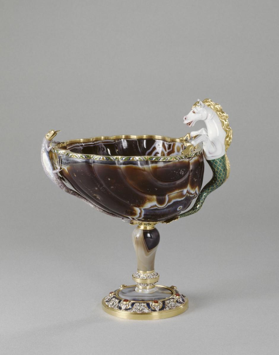 <a><img class=" wp-image-1769837 " src="https://www.theepochtimes.com/assets/uploads/2015/09/Shell-shaped+cup.jpg" alt="This shell-shaped cup with two figures in the form of a fish-tailed horse and snake-headed lizard is currently on view at the Legion of Honor. Cup (Byzantium): sardonyx, mounts (Paris, France): enameled gold, gilt copper, diamonds, sapphires, and rubies, with later additions, 10th–11th century, 7.7 inches by 7.1 inches in diameter.  (RMN-Grand Palais / Art Resource, NY / Daniel Arnaudet)" width="323" height="413"/></a>