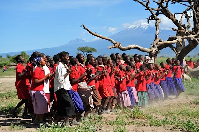 <a><img class="size-large wp-image-1782929" title="Students from Esiteti Primary School sing with Mount Kilimanjaro in the background. (Courtesy of ASK)" src="https://www.theepochtimes.com/assets/uploads/2015/09/The-students-singing-with-Mt.-Kilimanjaro-in-background.jpg" alt="Students from Esiteti Primary School sing with Mount Kilimanjaro in the background. (Courtesy of ASK)" width="590" height="392"/></a>