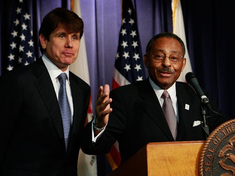 <a><img src="https://www.theepochtimes.com/assets/uploads/2015/09/bagboy84144417.jpg" alt="Illinois Governor Rod Blagojevich (L) looks on as former Illinois Attorney General Roland Burris (R), speaks during a press conference at the Thompson Center December 30, 2008 in Chicago, Illinois. (Scott Olson/Getty Images)" title="Illinois Governor Rod Blagojevich (L) looks on as former Illinois Attorney General Roland Burris (R), speaks during a press conference at the Thompson Center December 30, 2008 in Chicago, Illinois. (Scott Olson/Getty Images)" width="320" class="size-medium wp-image-1831888"/></a>