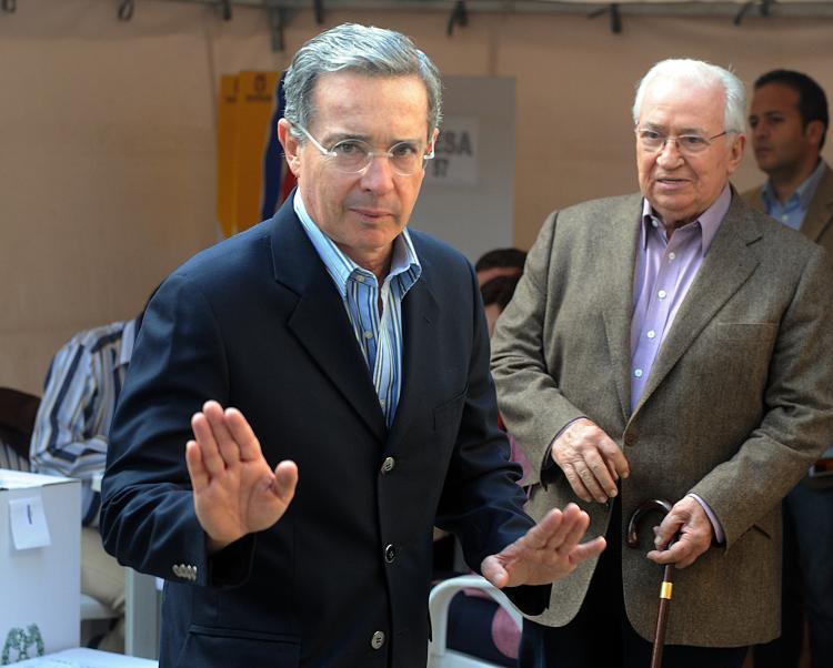 <a><img src="https://www.theepochtimes.com/assets/uploads/2015/09/colombia_97693130.jpg" alt="Colombian President Alvaro Uribe waves to journalists after casting his vote during the legislative elections, in Bogota on March 14. Uribe is considering a hostage swap with Colombia's largest rebel group, Farc. (Rodrigo Arangua/AFP/Getty Images)" title="Colombian President Alvaro Uribe waves to journalists after casting his vote during the legislative elections, in Bogota on March 14. Uribe is considering a hostage swap with Colombia's largest rebel group, Farc. (Rodrigo Arangua/AFP/Getty Images)" width="320" class="size-medium wp-image-1821594"/></a>