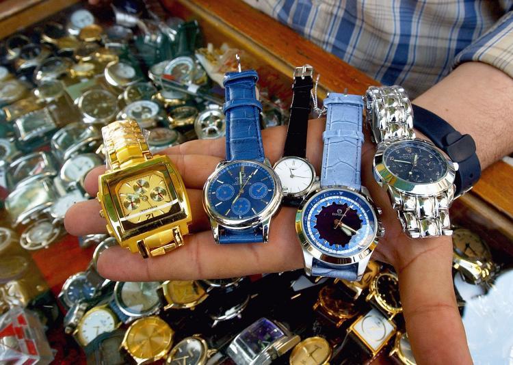 <a><img src="https://www.theepochtimes.com/assets/uploads/2015/09/counterfeits.jpg" alt="A watch-seller shows his fake watches including Rolexes for about $15 or $20.  (Wathiq Khuzaie/Getty Images)" title="A watch-seller shows his fake watches including Rolexes for about $15 or $20.  (Wathiq Khuzaie/Getty Images)" width="320" class="size-medium wp-image-1830518"/></a>