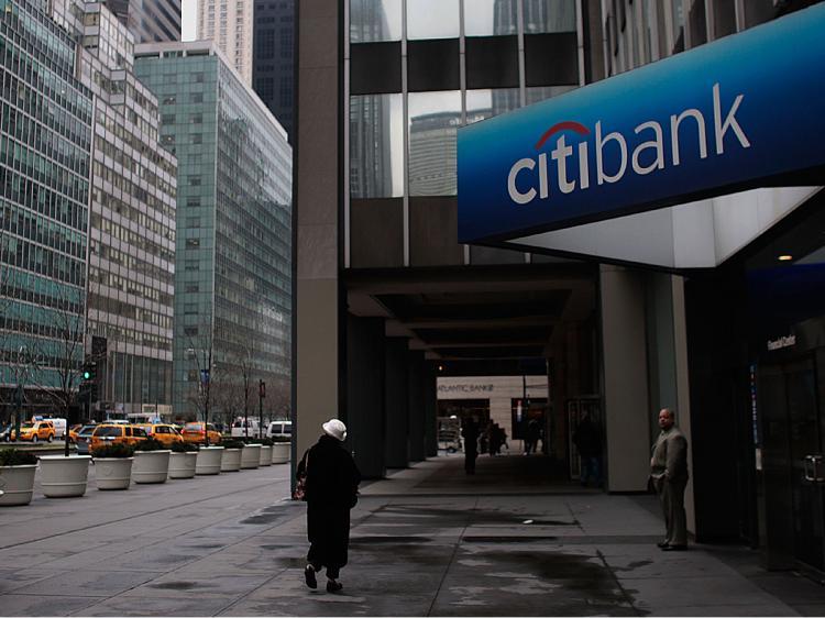<a><img src="https://www.theepochtimes.com/assets/uploads/2015/09/crank85531638.jpg" alt="A woman walks by a Citibank branch bank in Midtown Manhattan March 20, 2009 in New York City.    (Chris Hondros/Getty Images)" title="A woman walks by a Citibank branch bank in Midtown Manhattan March 20, 2009 in New York City.    (Chris Hondros/Getty Images)" width="320" class="size-medium wp-image-1829315"/></a>