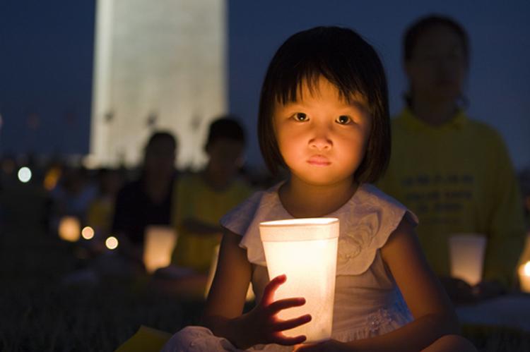 <a><img src="https://www.theepochtimes.com/assets/uploads/2015/09/dcv_ss3.jpg" alt="A young girl is illuminated by candle light during the commemorative vigil on July 18. (Shaoshao Chen/The Epoch Times)" title="A young girl is illuminated by candle light during the commemorative vigil on July 18. (Shaoshao Chen/The Epoch Times)" width="320" class="size-medium wp-image-1834887"/></a>