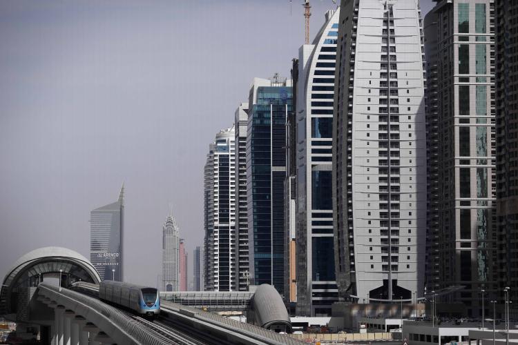 <a><img src="https://www.theepochtimes.com/assets/uploads/2015/09/dubai_93610599_WEB.jpg" alt="A passenger train passes in front of high rise buildings on Dec. 2, in Dubai, United Arab Emirates. Neighbor Abu Dhabi bailed Dubai out with a handout of $10 billion. (Dan Kitwood/Getty Images)" title="A passenger train passes in front of high rise buildings on Dec. 2, in Dubai, United Arab Emirates. Neighbor Abu Dhabi bailed Dubai out with a handout of $10 billion. (Dan Kitwood/Getty Images)" width="320" class="size-medium wp-image-1824713"/></a>