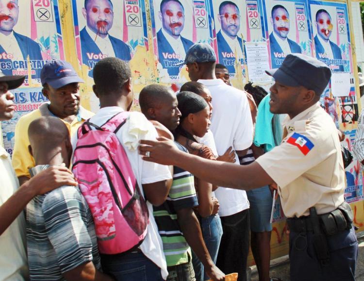 <a><img src="https://www.theepochtimes.com/assets/uploads/2015/09/haiti107076435-WEB.jpg" alt="A police officer keeps order, as people stand in line to get their federal identification card, which they will need to be able vote on Nov. 28 in Port-au-Prince, Haiti. Haiti is experiencing a cholera epidemic, and some fear violence in the upcoming elections. Nineteen candidates are running for president, four of whom are calling for the elections to be postponed. (Joe Raedle/Getty Images)" title="A police officer keeps order, as people stand in line to get their federal identification card, which they will need to be able vote on Nov. 28 in Port-au-Prince, Haiti. Haiti is experiencing a cholera epidemic, and some fear violence in the upcoming elections. Nineteen candidates are running for president, four of whom are calling for the elections to be postponed. (Joe Raedle/Getty Images)" width="320" class="size-medium wp-image-1811627"/></a>
