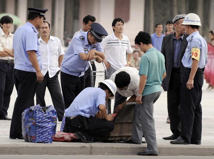 <a><img src="https://www.theepochtimes.com/assets/uploads/2015/09/hg.jpg" alt="Police in Kashgar (a major city along the Silk Road in Northwestern Xinjiang) stop a few ethnic Uighurs to inspect their bags. (AFP/Getty Images)" title="Police in Kashgar (a major city along the Silk Road in Northwestern Xinjiang) stop a few ethnic Uighurs to inspect their bags. (AFP/Getty Images)" width="320" class="size-medium wp-image-1834370"/></a>