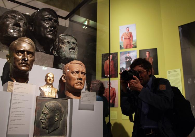 <a><img src="https://www.theepochtimes.com/assets/uploads/2015/09/hitler_exhibition_105236647.jpg" alt="A visitor takes a picture of busts of Nazi criminal Adolf Hitler during a press preview of 'Hitler and the Germans Nation and Crime' at the German Historical Museum on October 13 in Berlin. (Andreas Rentz/Getty Images)" title="A visitor takes a picture of busts of Nazi criminal Adolf Hitler during a press preview of 'Hitler and the Germans Nation and Crime' at the German Historical Museum on October 13 in Berlin. (Andreas Rentz/Getty Images)" width="320" class="size-medium wp-image-1813441"/></a>