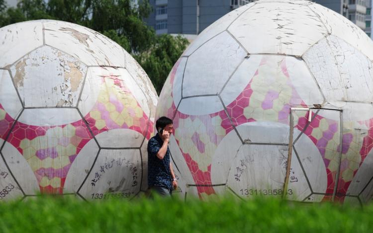 <a><img src="https://www.theepochtimes.com/assets/uploads/2015/09/interpol+soccer+football+gambling.jpg" alt="A man on his cell phone walks past giant footballs in Beijing on June 23, 2010. Though gambling is outlawed in China, it has not stopped a thriving underground industry, which manifested in gambling syndicates and online betting during the World Cup.  (Frederic J. Brown/AFP/Getty Images)" title="A man on his cell phone walks past giant footballs in Beijing on June 23, 2010. Though gambling is outlawed in China, it has not stopped a thriving underground industry, which manifested in gambling syndicates and online betting during the World Cup.  (Frederic J. Brown/AFP/Getty Images)" width="320" class="size-medium wp-image-1817293"/></a>