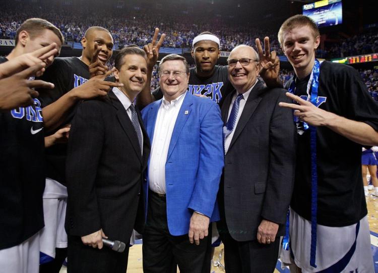 <a><img src="https://www.theepochtimes.com/assets/uploads/2015/09/kentucky.jpg" alt="John Calipari (left in suit), Joe Hall (middle), who coached Kentucky to a national championship, and Herky Rupp (right), son of former coach Adolph Rupp, celebrate with current Wildcats players after their 2,000th win on Monday night. (Andy Lyons/Getty Images)" title="John Calipari (left in suit), Joe Hall (middle), who coached Kentucky to a national championship, and Herky Rupp (right), son of former coach Adolph Rupp, celebrate with current Wildcats players after their 2,000th win on Monday night. (Andy Lyons/Getty Images)" width="320" class="size-medium wp-image-1824538"/></a>
