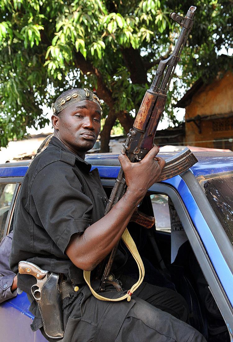 <a><img src="https://www.theepochtimes.com/assets/uploads/2015/09/merk84120235.jpg" alt="A mutinous soldier brandishes his weapon as he rides through the streets of Guinea's capital Conakry on December 24, 2008 in Conakry, following a coup. (Seyllou/AFP/Getty Images)" title="A mutinous soldier brandishes his weapon as he rides through the streets of Guinea's capital Conakry on December 24, 2008 in Conakry, following a coup. (Seyllou/AFP/Getty Images)" width="320" class="size-medium wp-image-1815966"/></a>