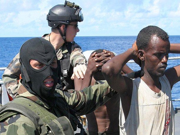 <a><img class="size-large wp-image-1775336" title="French soldiers guard suspected Somali pirates on board the French warship Le Nivose, after their capture on May 3, 2009, as part of EU's Atalante anti-piracy naval mission. The number of ships signaling attacks by Somali pirates has fallen this year to its lowest since 2009, a report from the International Chamber of Commerce International Maritime Bureau (IMB) revealed, but IMB warns seafarers need to remain vigilant in high-risk waters around Somalia, the Gulf of Aden, and the Red Sea. Meanwhile, violent attacks and hijackings are spreading in the Gulf of Guinea. " src="https://www.theepochtimes.com/assets/uploads/2015/09/pirates86356547.jpg" alt="French soldiers guard suspected Somali pirates on board the French warship Le Nivose, after their capture on May 3, 2009, as part of EU's Atalante anti-piracy naval mission. The number of ships signaling attacks by Somali pirates has fallen this year to its lowest since 2009, a report from the International Chamber of Commerce International Maritime Bureau (IMB) revealed, but IMB warns seafarers need to remain vigilant in high-risk waters around Somalia, the Gulf of Aden, and the Red Sea. Meanwhile, violent attacks and hijackings are spreading in the Gulf of Guinea. " width="590" height="442"/></a>