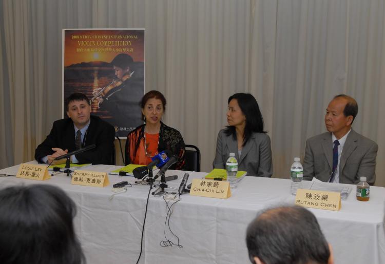 <a><img src="https://www.theepochtimes.com/assets/uploads/2015/09/pressconference.jpg" alt="The judges panel at NTDTV's International Chinese Violin Competition hold a press conference following the first round of judging. (The Epoch Times)" title="The judges panel at NTDTV's International Chinese Violin Competition hold a press conference following the first round of judging. (The Epoch Times)" width="320" class="size-medium wp-image-1834651"/></a>