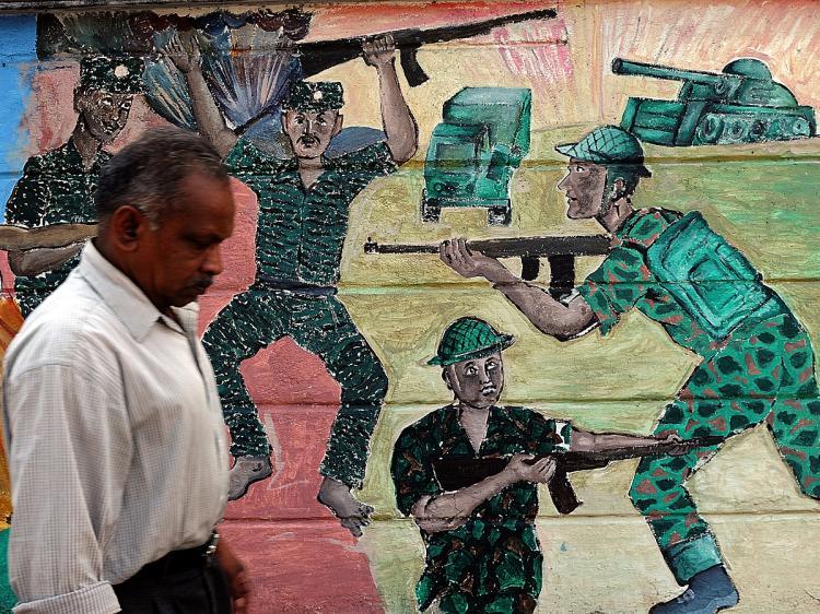 <a><img src="https://www.theepochtimes.com/assets/uploads/2015/09/sanka95908637.jpg" alt="WAR CRIMES: A Sri Lankan man walks past a painting on a wall depicting the recent war between the Sri Lankan army and the Liberation Tigers of Tamil Eelam (LTTE) in Colombo. (Indranil Mukherjee/AFP/Getty Images)" title="WAR CRIMES: A Sri Lankan man walks past a painting on a wall depicting the recent war between the Sri Lankan army and the Liberation Tigers of Tamil Eelam (LTTE) in Colombo. (Indranil Mukherjee/AFP/Getty Images)" width="320" class="size-medium wp-image-1819711"/></a>