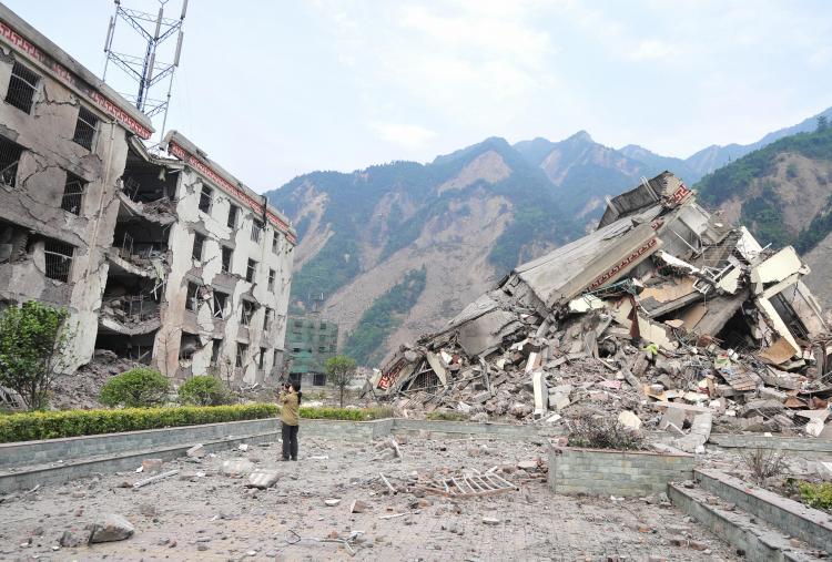 <a><img src="https://www.theepochtimes.com/assets/uploads/2015/09/sc81210314.jpg" alt="A woman documents the remains of a demolished school in the devastated town of Yingxiu in southwest China's quake-stricken Sichuan province. (Frederic J. Brown/AFP/Getty Images)" title="A woman documents the remains of a demolished school in the devastated town of Yingxiu in southwest China's quake-stricken Sichuan province. (Frederic J. Brown/AFP/Getty Images)" width="320" class="size-medium wp-image-1829487"/></a>