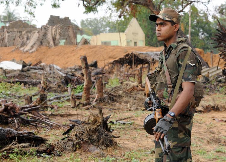 <a><img src="https://www.theepochtimes.com/assets/uploads/2015/09/srlk84489833.jpg" alt="Skeletal remains of civilian houses are seen in the background as a Sri Lankan soldier stand guard inside newly cleared area of Chilawatte on Jan. 27, 2009 in the Mullaittivu district, the former military headquarters of the Tamil Tiger rebels.  (Ishara S. Kodikara/AFP/Getty Images)" title="Skeletal remains of civilian houses are seen in the background as a Sri Lankan soldier stand guard inside newly cleared area of Chilawatte on Jan. 27, 2009 in the Mullaittivu district, the former military headquarters of the Tamil Tiger rebels.  (Ishara S. Kodikara/AFP/Getty Images)" width="320" class="size-medium wp-image-1830945"/></a>