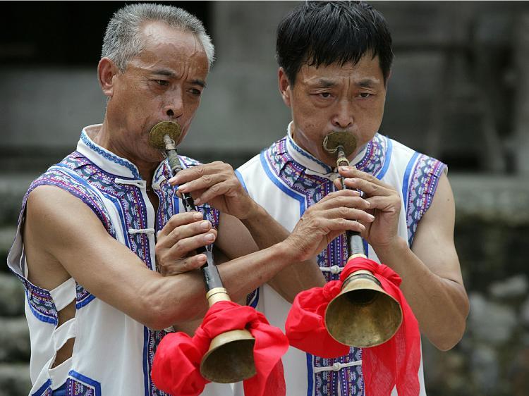 TRADITIONAL SUONA PLAYERS: Chinese farmers play suonas, a traditional Chinese woodwind instrument. (China Photos/Getty Images)