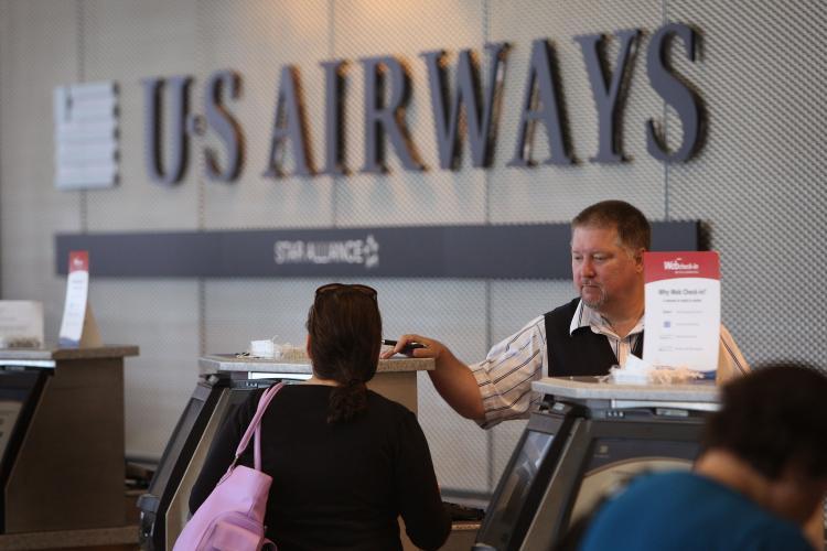 <a><img src="https://www.theepochtimes.com/assets/uploads/2015/09/us_airways_89043797.jpg" alt="In this file photo, a passenger checks in for a flight at the U.S. Airways counter at O'Hare Airport in Chicago, Illinois. The airline announced that it would cut 1,000 jobs and focus on some core routes as it struggles to return to profitability. (Scott Olson/Getty Images)" title="In this file photo, a passenger checks in for a flight at the U.S. Airways counter at O'Hare Airport in Chicago, Illinois. The airline announced that it would cut 1,000 jobs and focus on some core routes as it struggles to return to profitability. (Scott Olson/Getty Images)" width="320" class="size-medium wp-image-1825533"/></a>