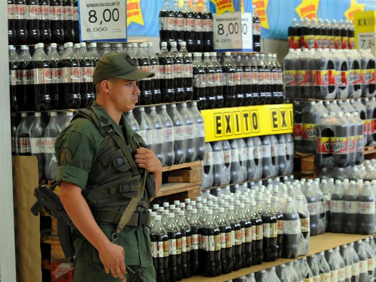 <a><img src="https://www.theepochtimes.com/assets/uploads/2015/09/venezuela-95691269.jpg" alt="A member of the Venezuelan National Guard stands guard in one of the aisles at a supermarket on January 11, 2010 in Caracas.  (Juan Barreto/AFP/Getty Images)" title="A member of the Venezuelan National Guard stands guard in one of the aisles at a supermarket on January 11, 2010 in Caracas.  (Juan Barreto/AFP/Getty Images)" width="320" class="size-medium wp-image-1824062"/></a>