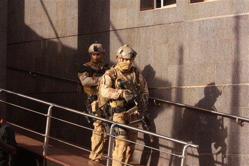 Soldiers leave the Radisson Blu hotel, after assisting Mali soldiers during an attack by gunmen on the hotel in Bamako, Mali, Friday, Nov. 20, 2015. (AP Photo/Harouna Traore)