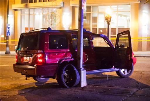 A vehicle is shown at the scene of an officer-involved shooting, Tuesday, Dec. 1, 2015, in downtown Atlanta, that left one person dead after an officer attempted to stop the vehicle on Monday. (AP Photo/David Goldman)