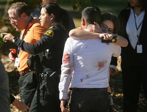 A couple embraces following a shooting that killed multiple people at a social services facility, Wednesday, Dec. 2, 2015, in San Bernardino, Calif. (David Bauman/The Press-Enterprise via AP)