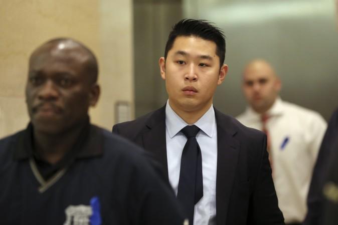 Police Officer Peter Liang, center, exits the courtroom during a break in closing arguments in his trial on charges in the shooting death of Akai Gurley, Tuesday, Feb. 9, 2016, at Brooklyn Supreme court in New York. (AP Photo/Mary Altaffer)