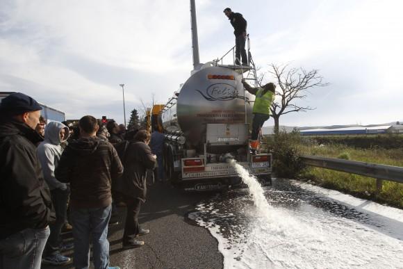 French winemakers watch wine flowing from the tap of a Spanish truck's tanker on April 4, 2016 in Le Boulon, 10 kilometers from the French-Spanish border, during a demonstration against southern countries' wine imports. (Raymond Roig/AFP/Getty)