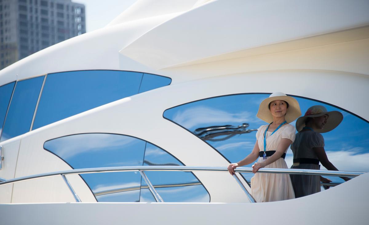A woman on a luxury yacht at a boat show at the port in the northeastern Chinese city of Dalian on July 5, 2014. Chinese buyers are being targeted by the world's yacht builders, whose vessels can cost as much as 100 million USD. (JOHANNES EISELE/AFP/Getty Images)
