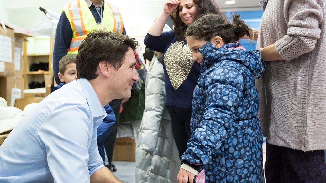 Canadian Prime Minister Justin Trudeau welcomes Syrian refugees to Canada late at night at Pearson International airport in Toronto, Dec. 10, 2015. (PMO Canada)