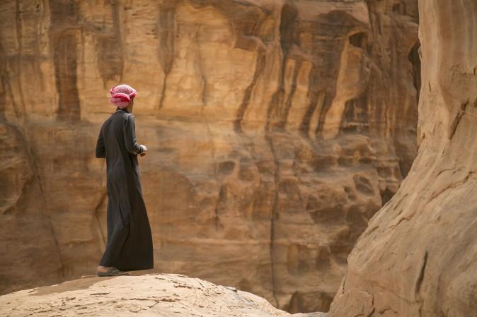 A Saudi man stands on the edge of a hill during a trip to the desert of Tabuk region, northwest of the capital Riyadh, on March 14, 2015. (Mohammed Albuhaisi/AFP/Getty Images)