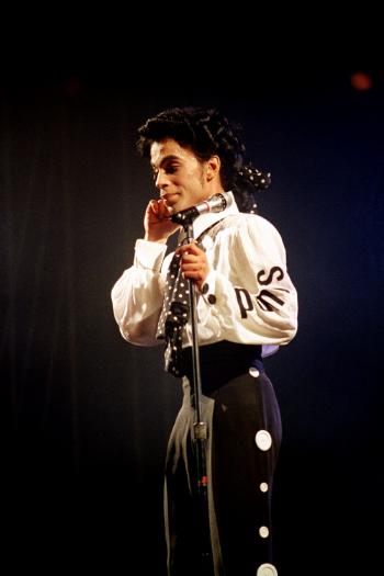 Prince pauses during his show at New York's Madison Square Garden Sunday night, Oct. 3, 1988. (AP Photo/Ed Bailey)